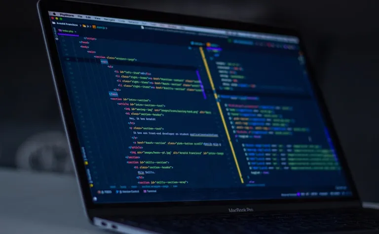 Custom web development with modern code displayed on a laptop screen